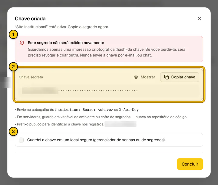 Diálogo Chave criada com o aviso de que o segredo não será exibido novamente, a chave mascarada e os botões Mostrar e Copiar chave.